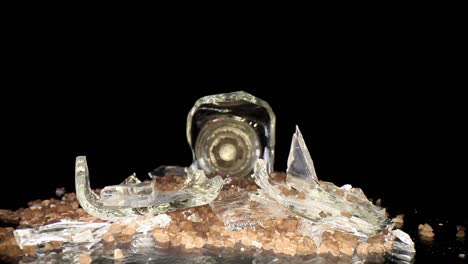 Pushing-towards-a-broken-sea-salt-grinder,-wide-angle-macro-view-of-the-broken-glass-and-salt-intermixed---salt-is-mesquite-flavored-hence-the-darker-color