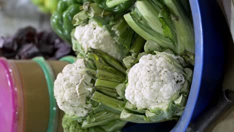 vertical view of fresh harvested broccoli vegetables for sale in the local market in uganda