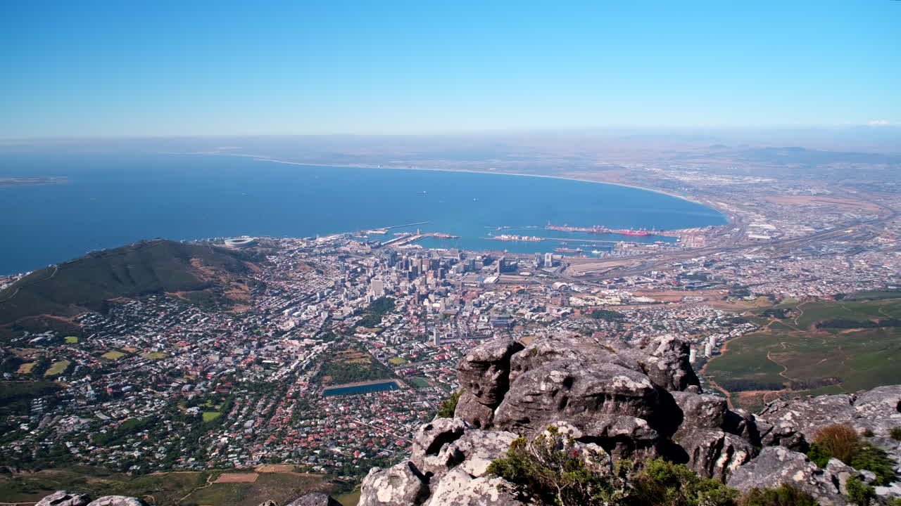 Panoramic pan shot over Cape Town city bowl and False Bay from Table Mountain