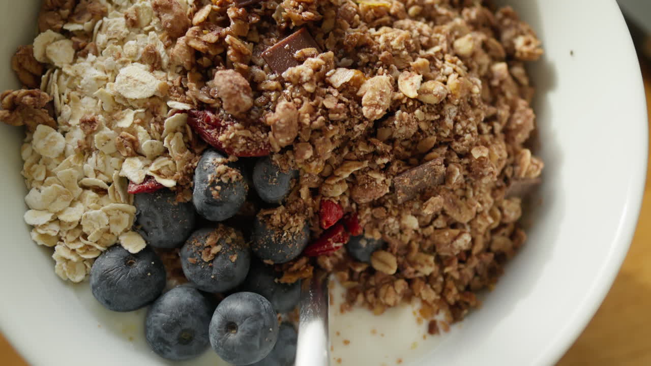 vista detallada de un plato de granola nutritivo con avena, chocolate y bayas