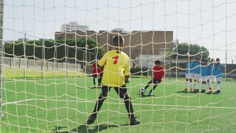 african american kid in red scoring in a sunny day