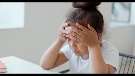 young girl using a laptop and a child showing frustration