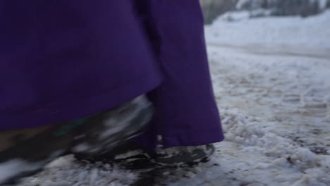 Close-Up-of-Legs-in-Winter-Boots-Walking-on-Slippery-Icy-Road-in-Snowy-Winter-Landscape-of-Mountain,-Full-Frame