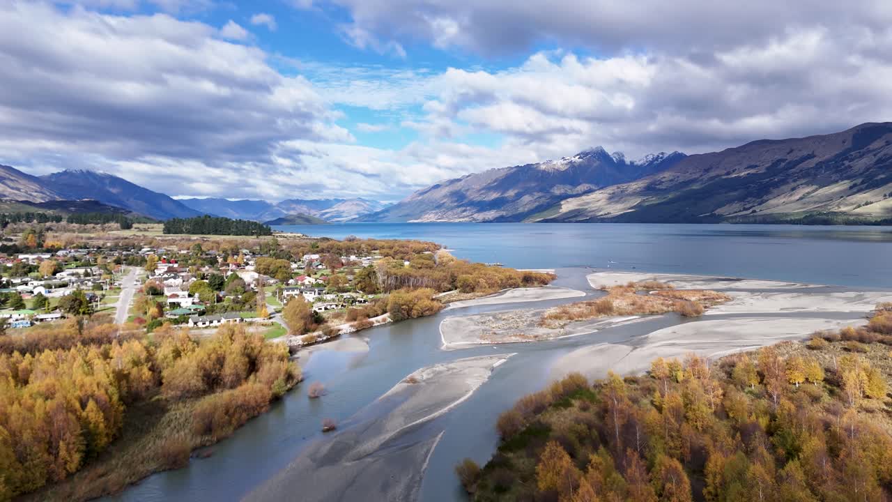 Aerial footage captures Glenorchy's stunning landscape with vibrant autumn foliage, winding rivers, and majestic mountains under dynamic skies