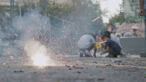 children and exploding firecracker on las fallas spain