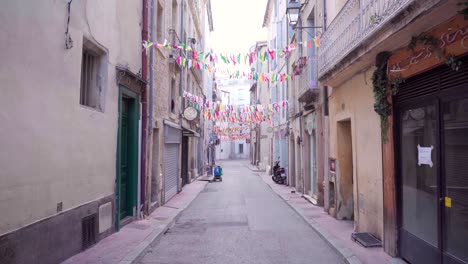 empty streets in countryside village with colorful tinsels, cancelled carnival, emptiness scenery during lockdown during the covid-19 pandemic