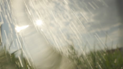 Water Sprinkler Watering Grass in Sunny Day