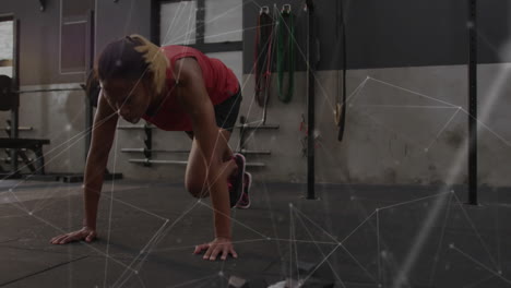 in gym, fitness enthusiast doing mountain climbers with animation of digital network