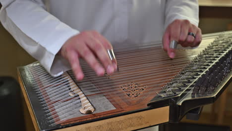 the qanun’s shimmering tones fill the air as an arab artist brings centuries-old music to life