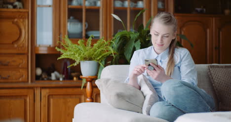 Happy-Woman-Browsing-Smartphone-At-Home-Businesswoman-Working-On-Smartphone-At-Home-Office-