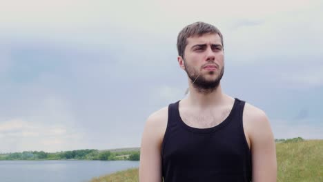 man outdoors by a lake