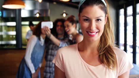 Happy-waitress-holding-tray-of-food-in-restaurant