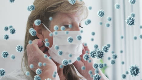 multiple covid-19 cells floating against caucasian senior woman wearing a face mask