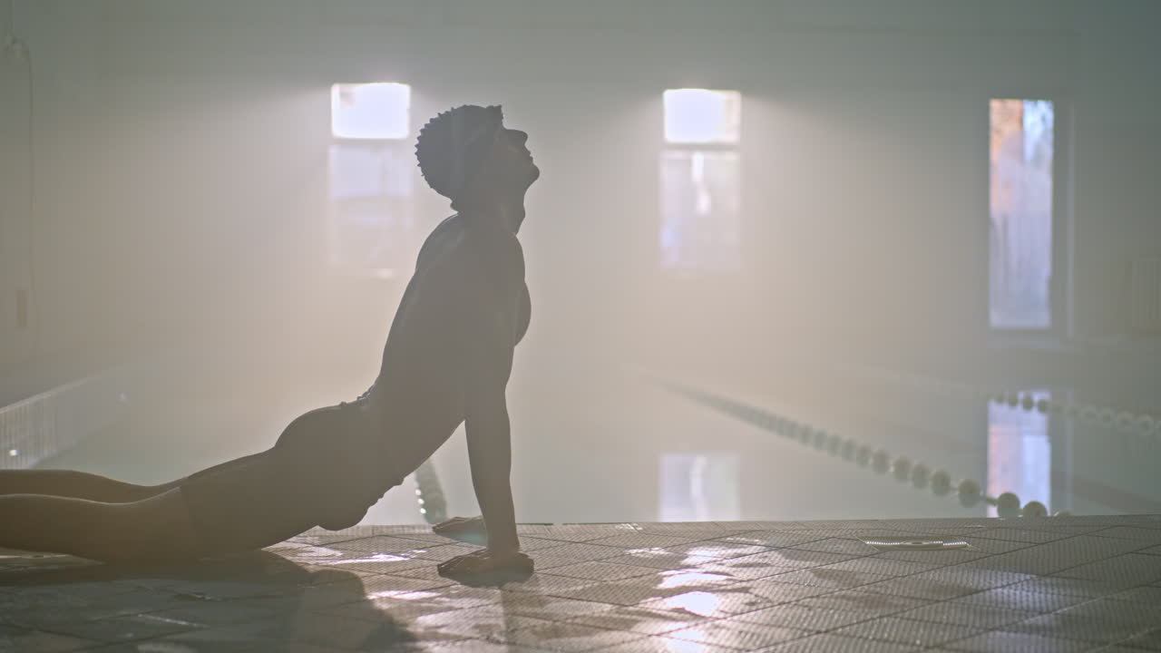 Man stretching at the swimming pool
