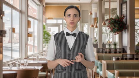 indian woman waiter talking to the customer