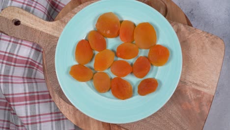 circular rotation a plate with dried apricot ,top view.