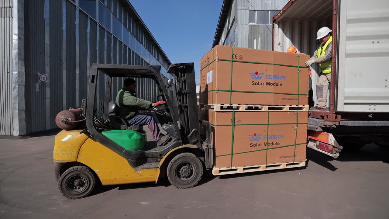 Forklift Loading Solar Panels into a Shipping Container