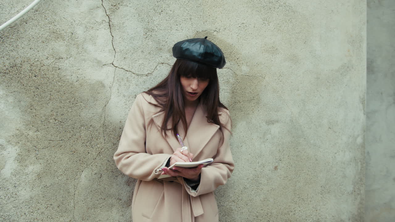 Happy Woman Outdoor Writing Ideas On A Notebook With A Pen