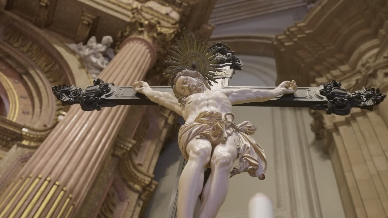 Dramatic low angle crucifix statue of Jesus Christ in church interior