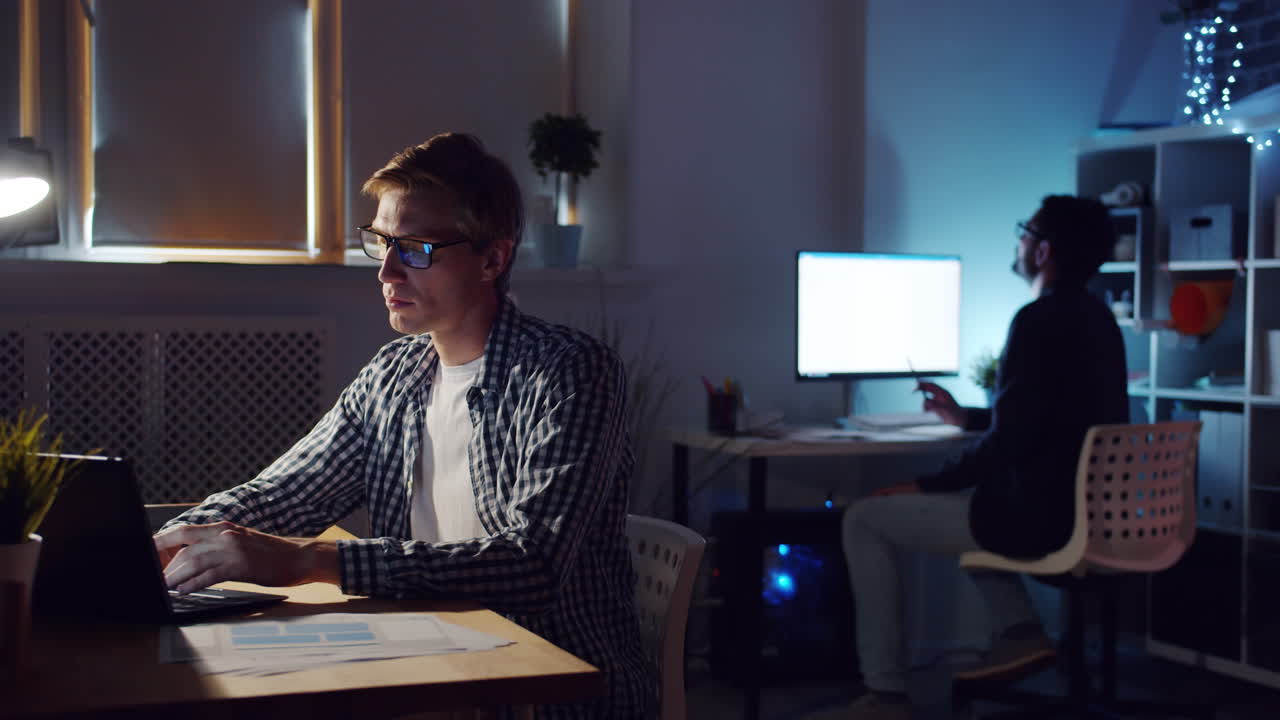 Two Colleagues Working Late in Office