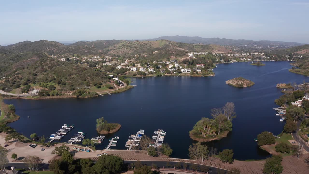 Aerial wide panning shot of a marina in the exclusive community of Lake Sherwood, California. 4K at 30 FPS