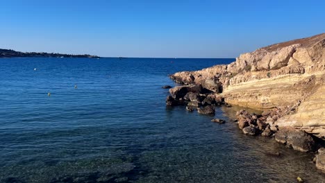 coastline with clear waters, rocky shore, and blue sky on crete island