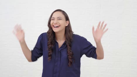 indian girl saying hi and waving hands