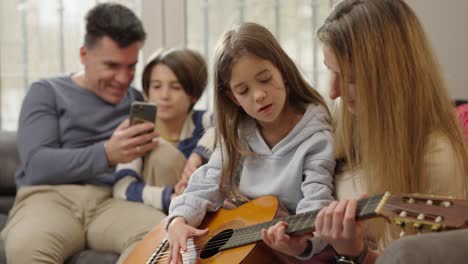 family bonding over guitar lessons at home