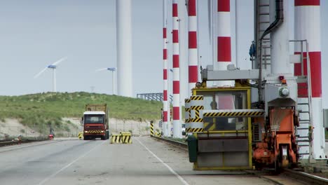 Panorama-view-of-sustainable-harbour,-cargo-container-crane-drives-on-tracks