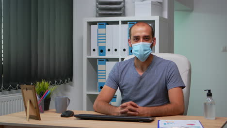 worker wearing mask and talking on camera