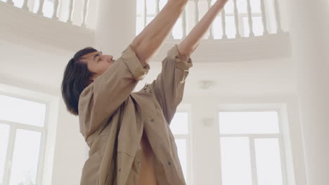 bottom view of contemporary male japanese dancer training dance moves in the middle of the studio 1