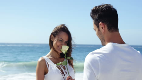 Man-offering-flower-to-girlfriend