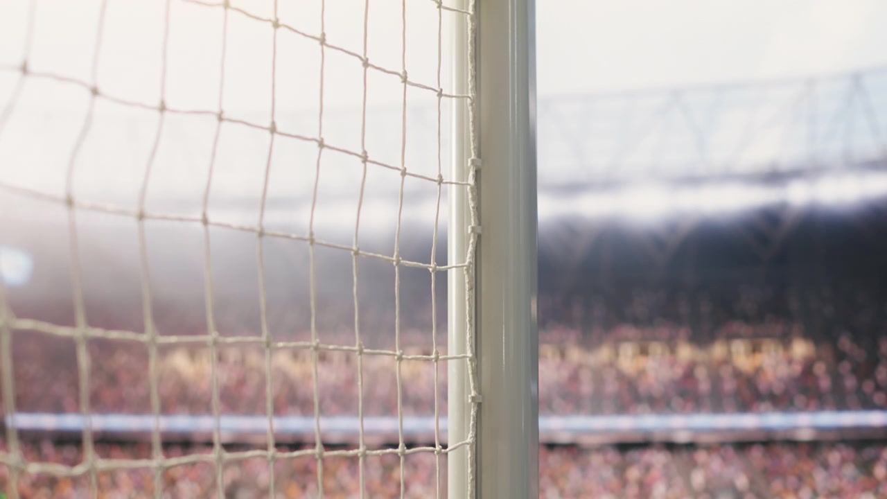 Low angle view of empty goal net and side post on football pitch