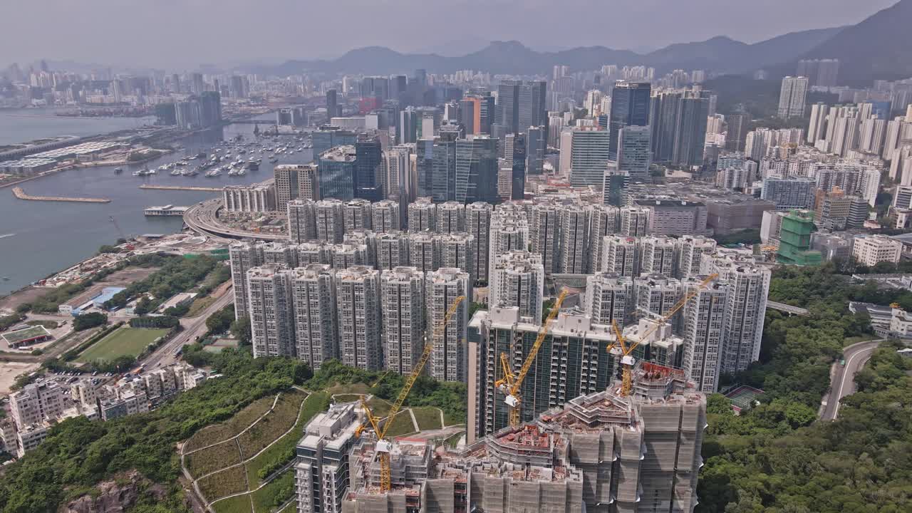 Aerial drone rotating shot over Laguna City, revealing Kwun Tong Typhoon Shelter along the bay area in Hong Kong, China on a sunny day