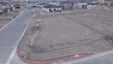 un avión no tripulado gira graciosamente alrededor de un lote aplanado, sistemáticamente preparado y listo para el comienzo de la construcción de una nueva casa