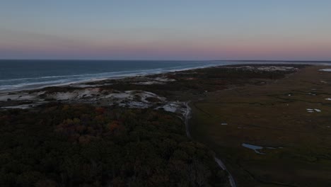 moving drone view of salt marsh and sand dunes during sunset at cape cod, barnstable massachusetts in usa. sea horizon.