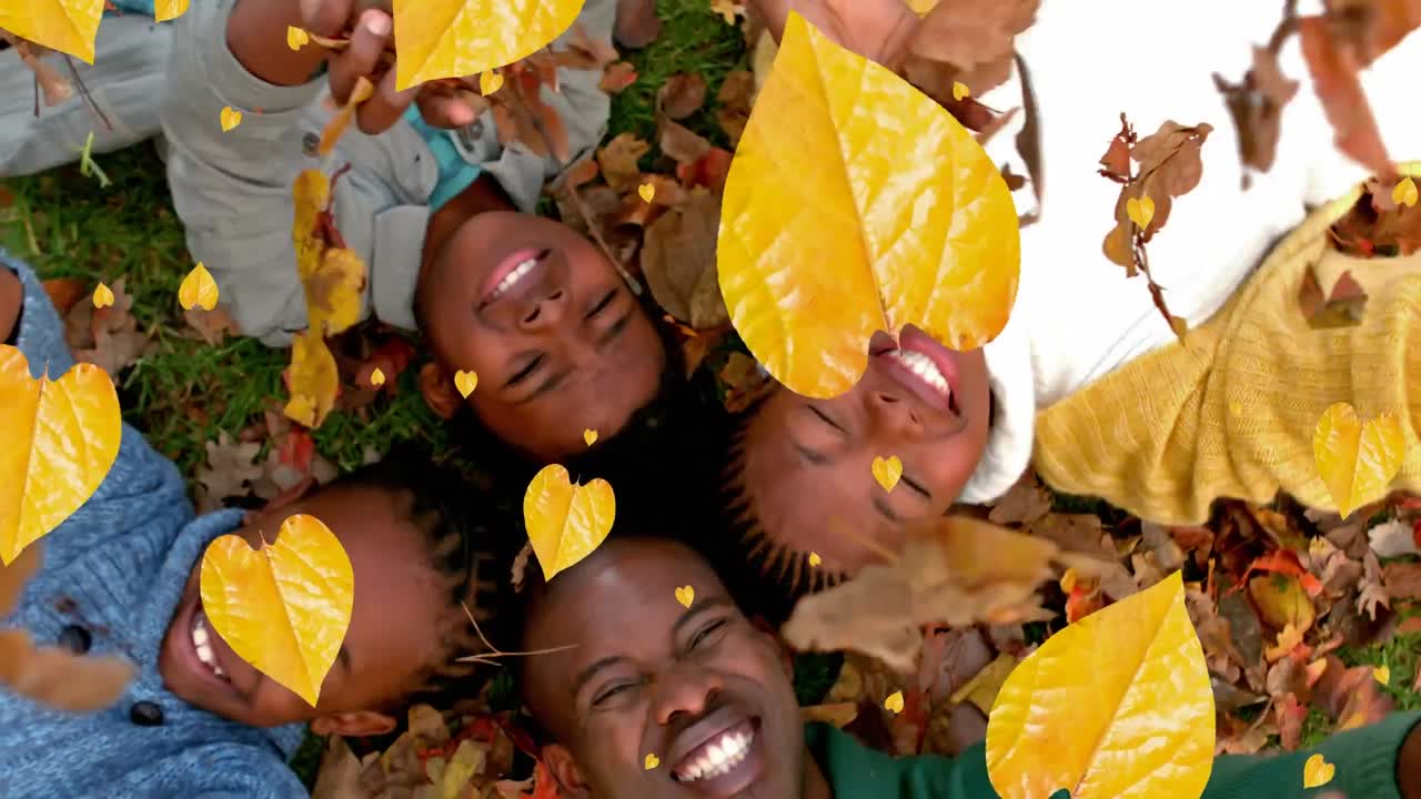 animación de hojas de otoño que caen sobre una feliz familia afroamericana en el parque