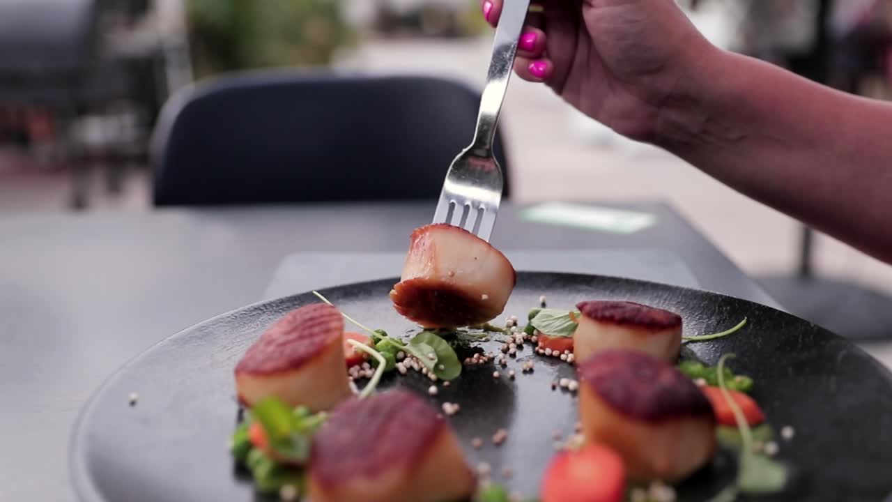 Premium Stock Video - Women At A Fancy Restaurant Eating Scallops