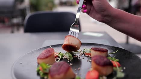 women at a fancy restaurant eating scallops