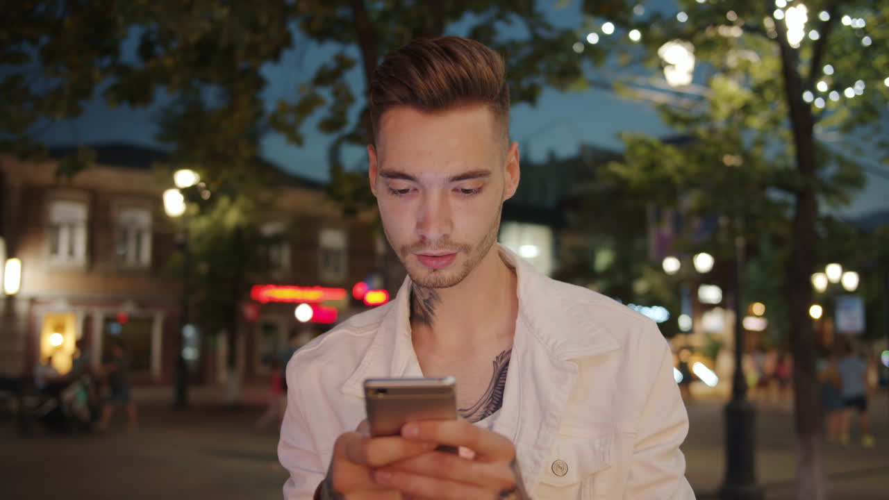 Man using smartphone at night in the city