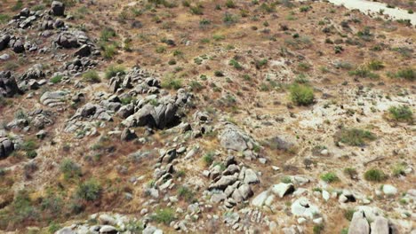 Aerial-short-flyover-boulder-field-and-balance-rock-on-the-floor-of-Sonoran-desert,-Scottsdale,-Arizona