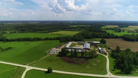 View-of-mowed-meadows-and-farm-from-drone-flight,-panoramic-view