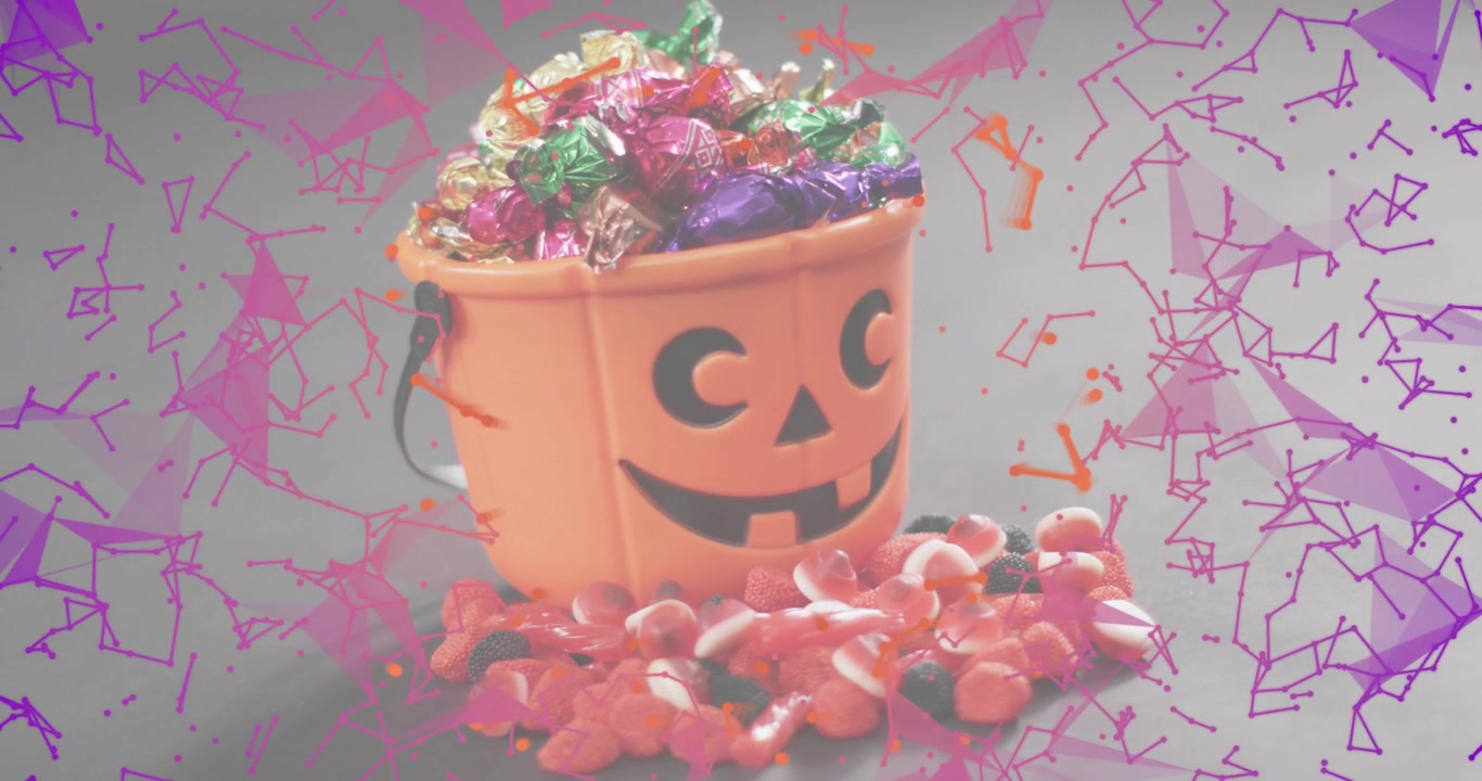Pink polygons drifting in then swirling around pumpkin pail, showing chocolate display on grey base
