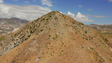 American-flag-on-top-of-a-hill-near-highway-15-near-Phelan,-California