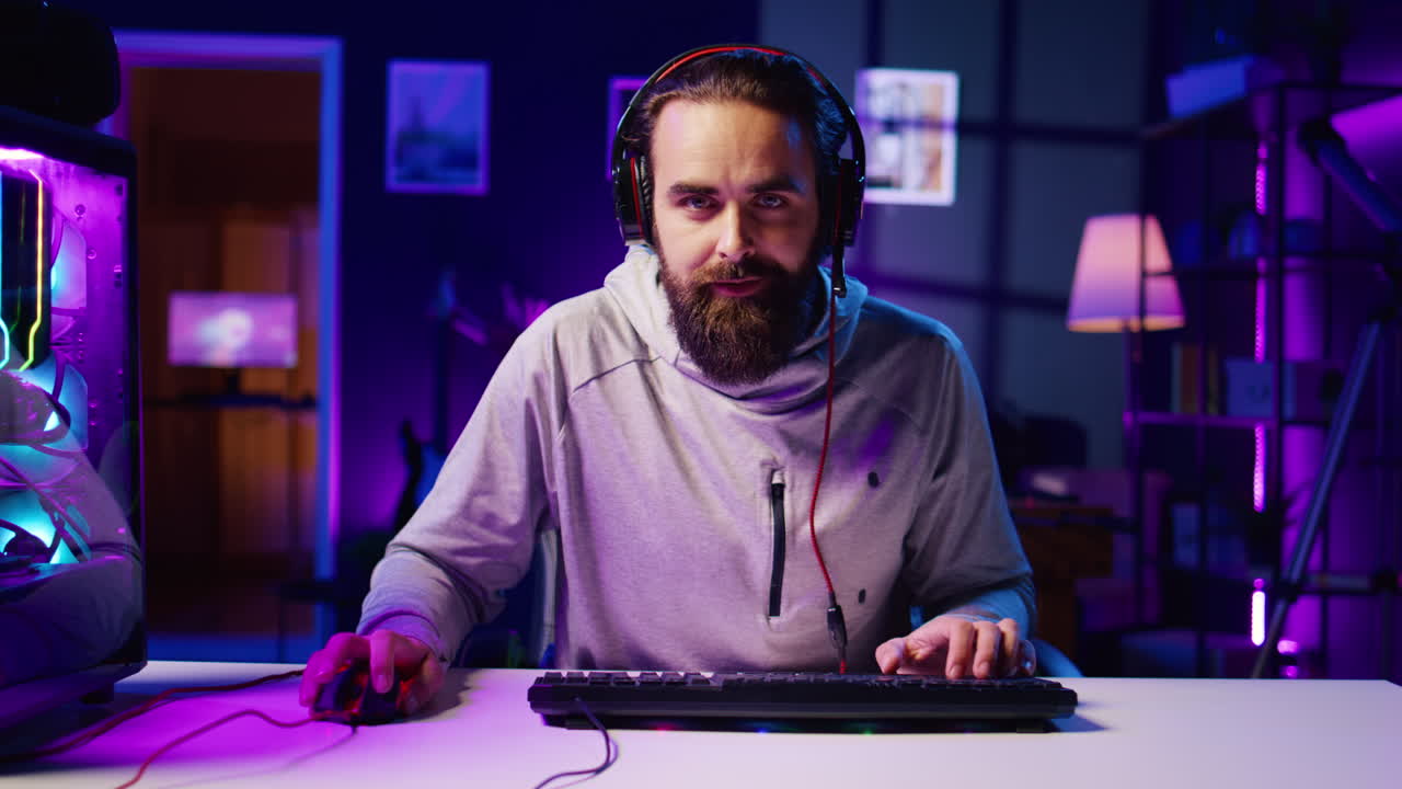 Man communicating with internet friends playing videogames, zoom out