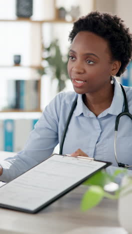 a female doctor examining a patient in her office.