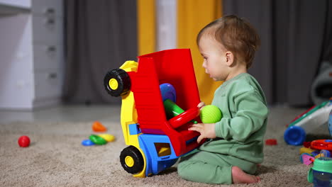 baby playing with toy truck