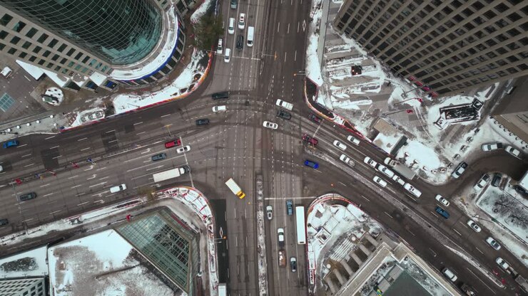 Overhead Vehicle Traffic 4K Hyper Time lapse Winter Drone Shot Canadian Roadway Trans Highway One Intersection Portage Avenue and Main Street Capital City Downtown Winnipeg Manitoba Canada