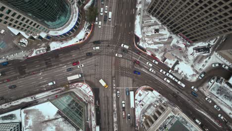 overhead vehicle traffic 4k hyper time lapse winter drone shot canadian roadway trans highway one intersection portage avenue and main street capital city downtown winnipeg manitoba canada