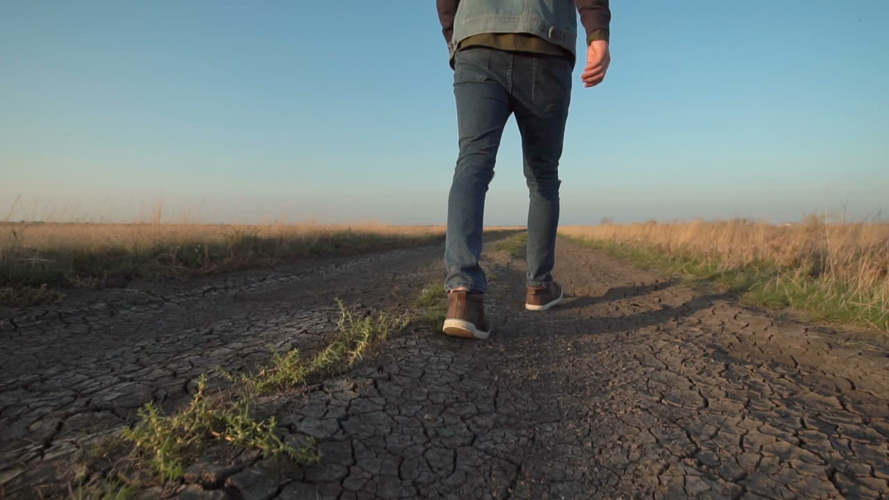 Man Walking on a Dusty Country Road